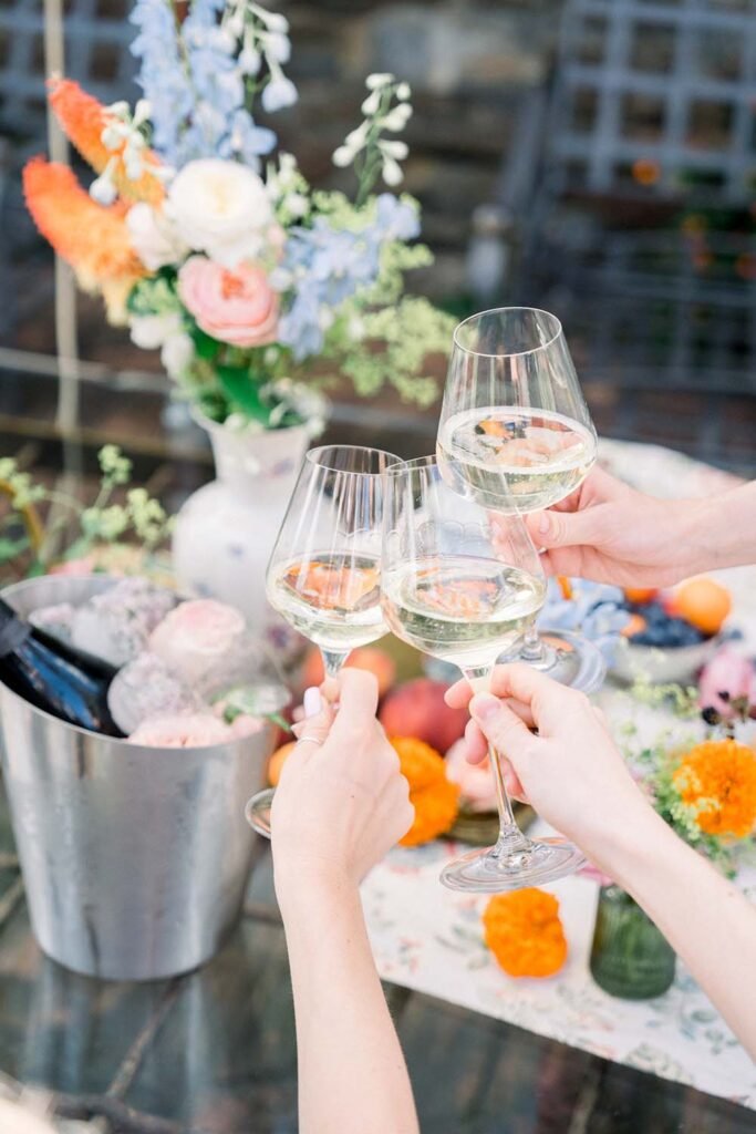 A picture of three clinking glasses at the table