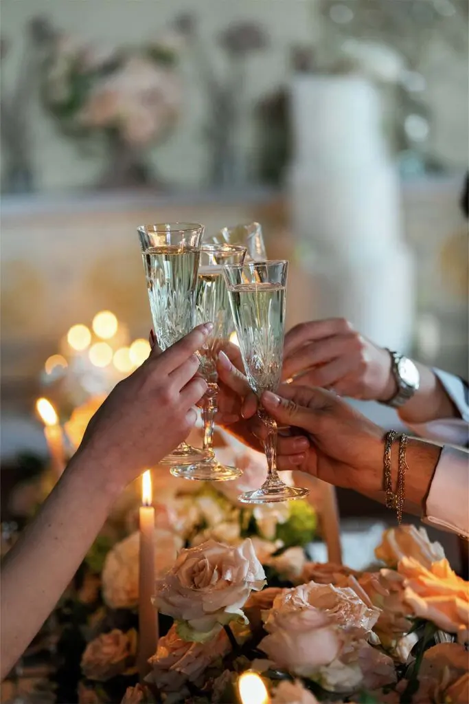 Clinking glasses at a table of candles