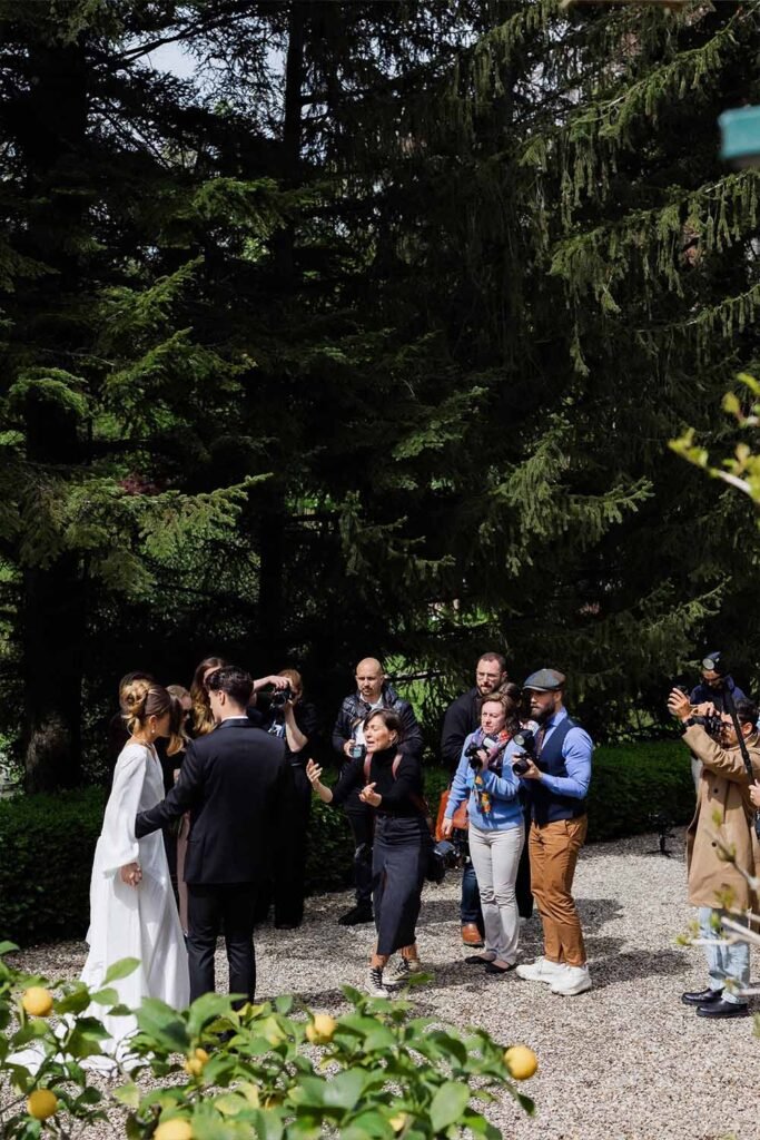 Models pose for photographers in the garden