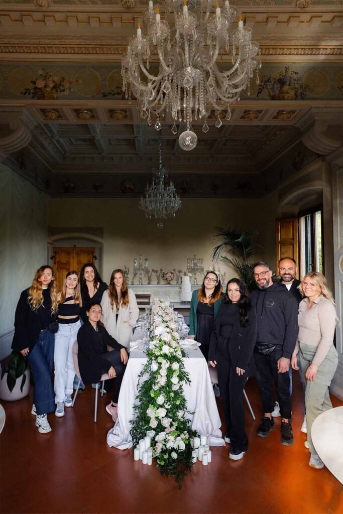 Collective photo of 10 people together in a room around a table