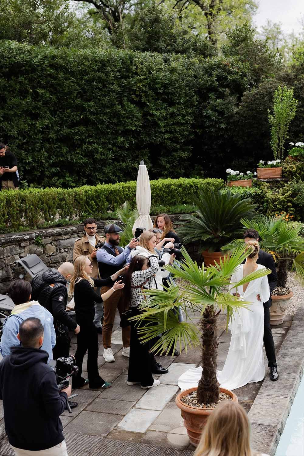 A couple poses for photographers in the garden