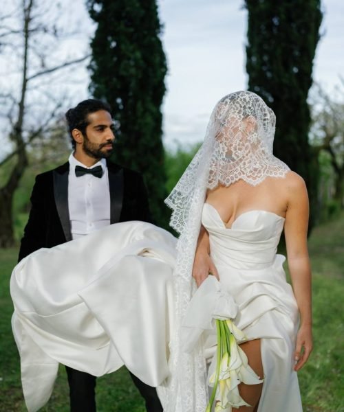 The bride and groom are walking in the garden